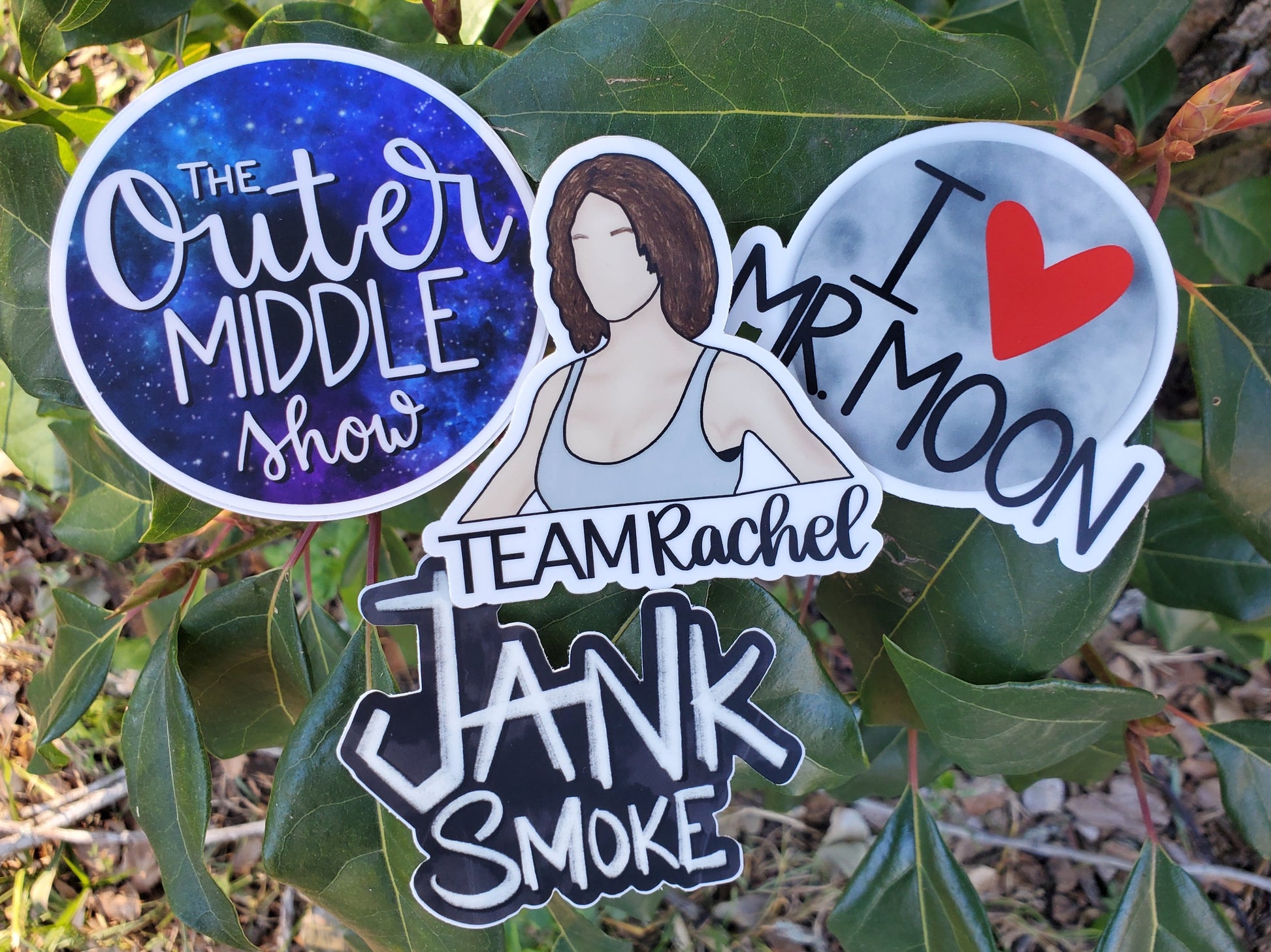 Madd Vladd sticker set. Round the outer middle show sticker with galaxy background. I heart Mr. Moon sticker with the moon as a background. Team Rachel sticker with drawing of Rachel's character in The Mist Survival. Jank Smoke text on black smokey background.